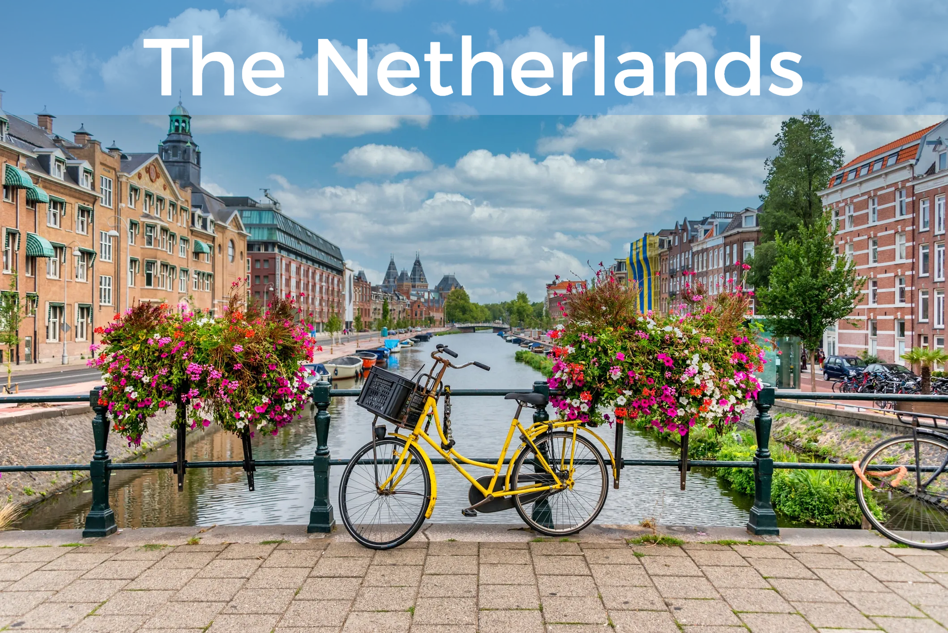Bicycle on bridge above canal with "The Netherlands" at top. Click to learn more about the Netherlands.