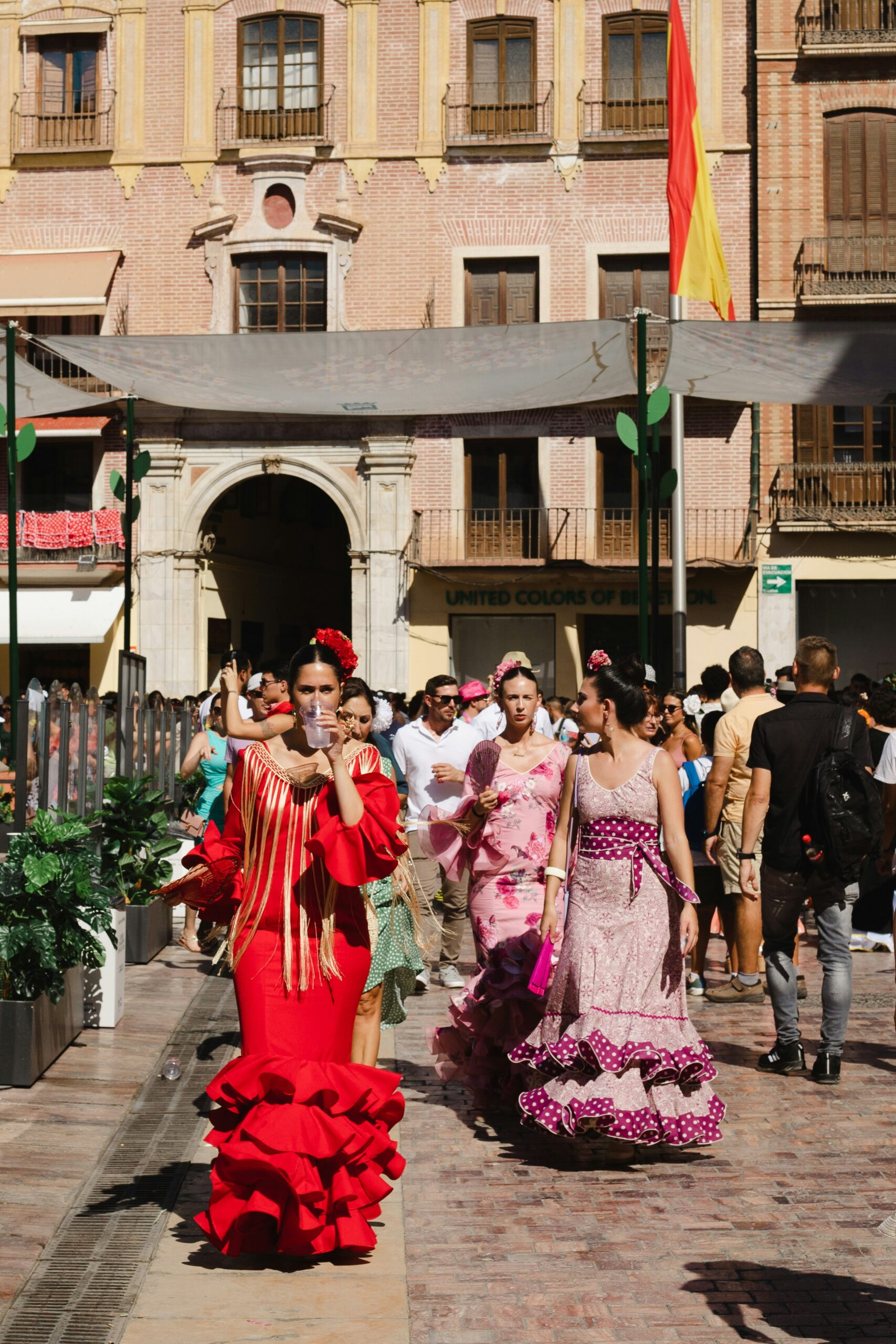 Spanish women in colorful traditional dresses on a sunny day in the town square