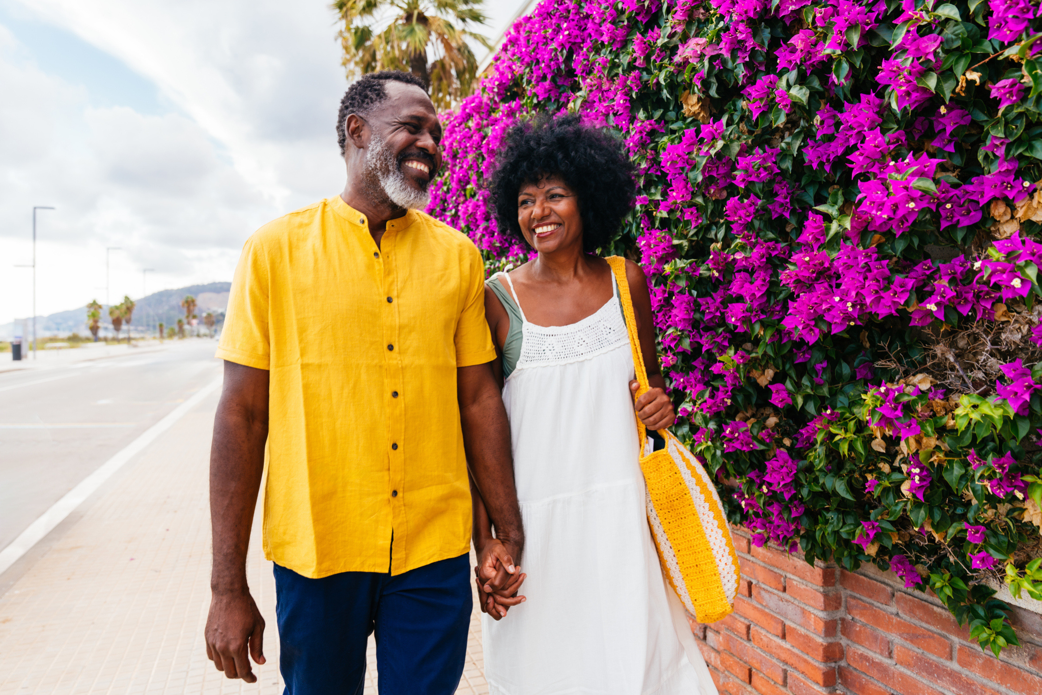 Retired couple walk by the sea