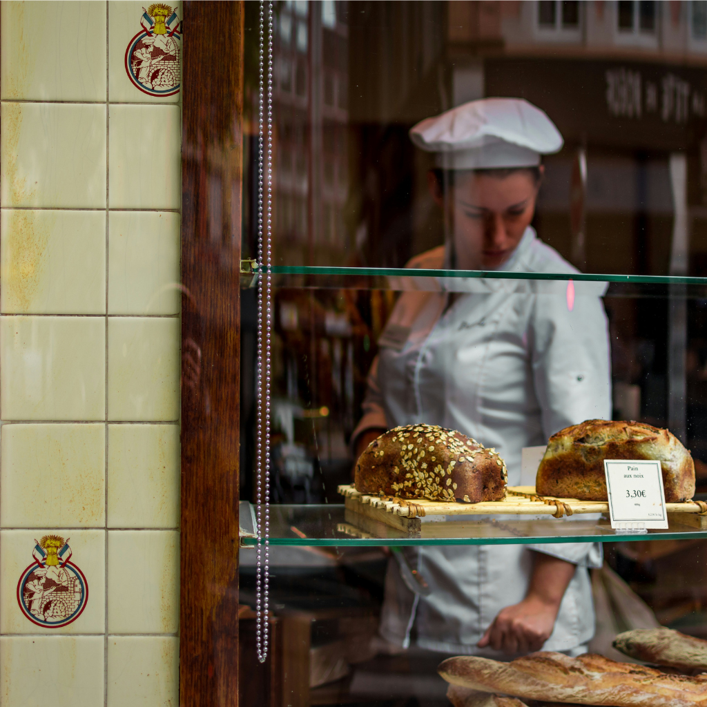 French baker looking at pastries in the window