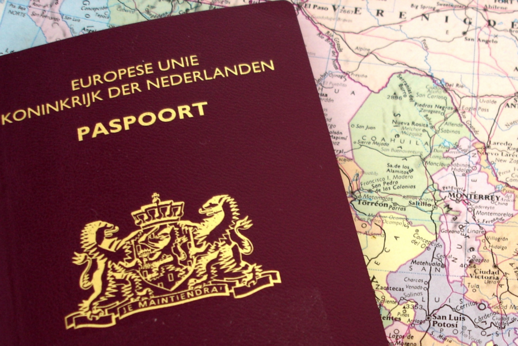 Dutch passport with map behind it