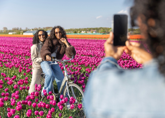 Women pose for a photo in flower fields