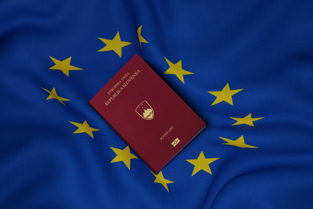 Slovenian passport with EU flag behind it