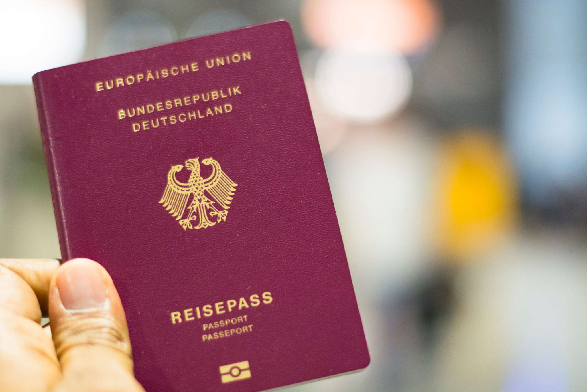 Hand holding a German passport