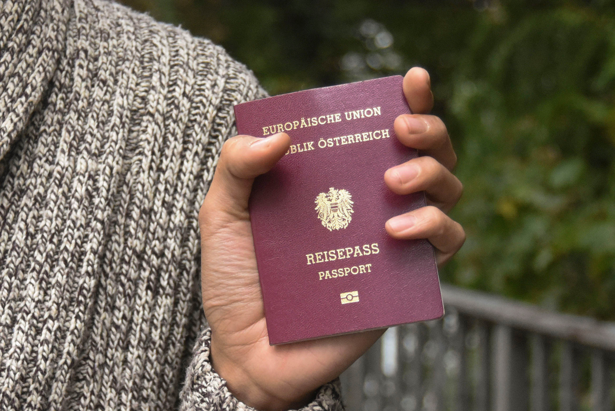 Man holding an Austrian passport