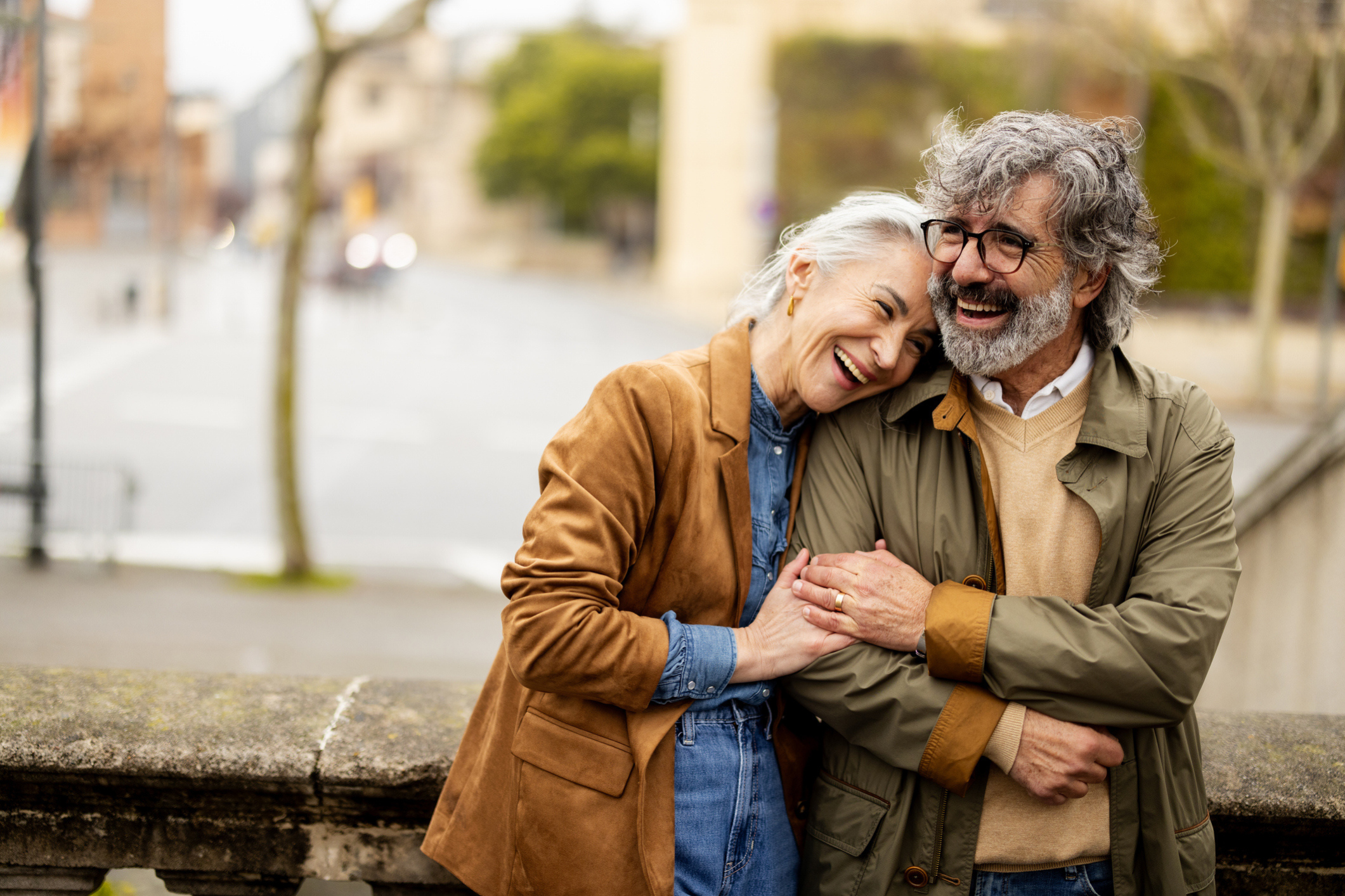 Stylish retired couple laughing on a European street