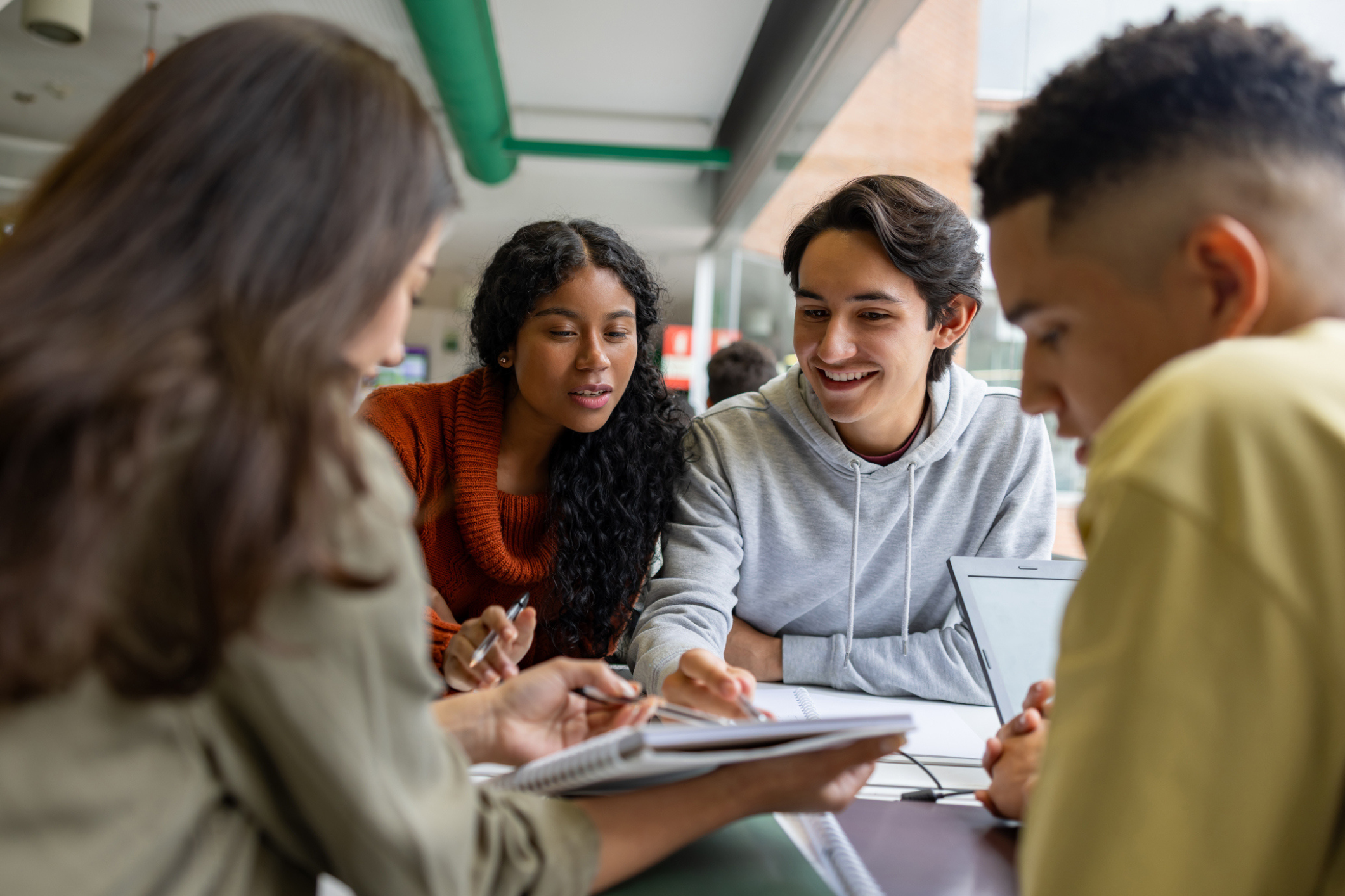 Four students (two men and two women) study books at a university