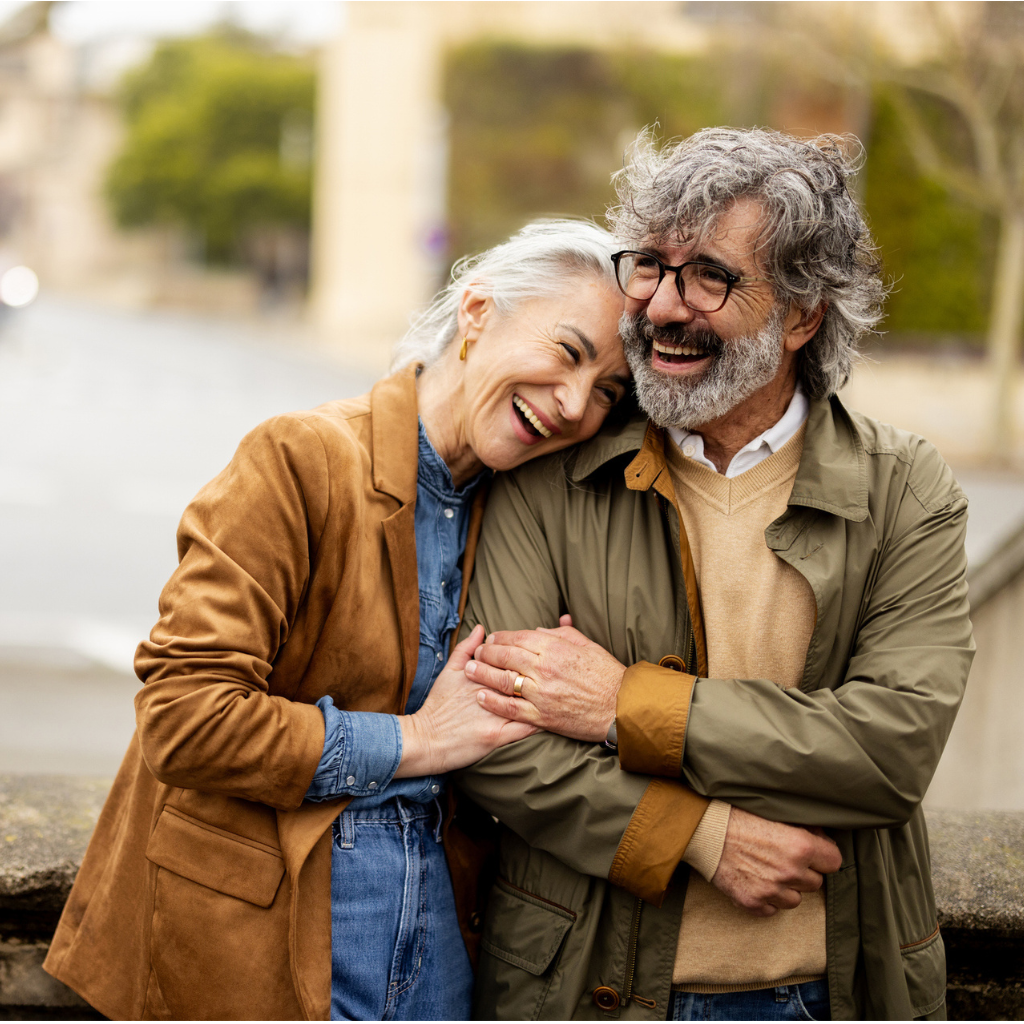 Retired couple smiling while embracing in Europe