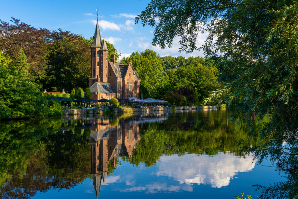 River flowing next to a historical church in Belgium