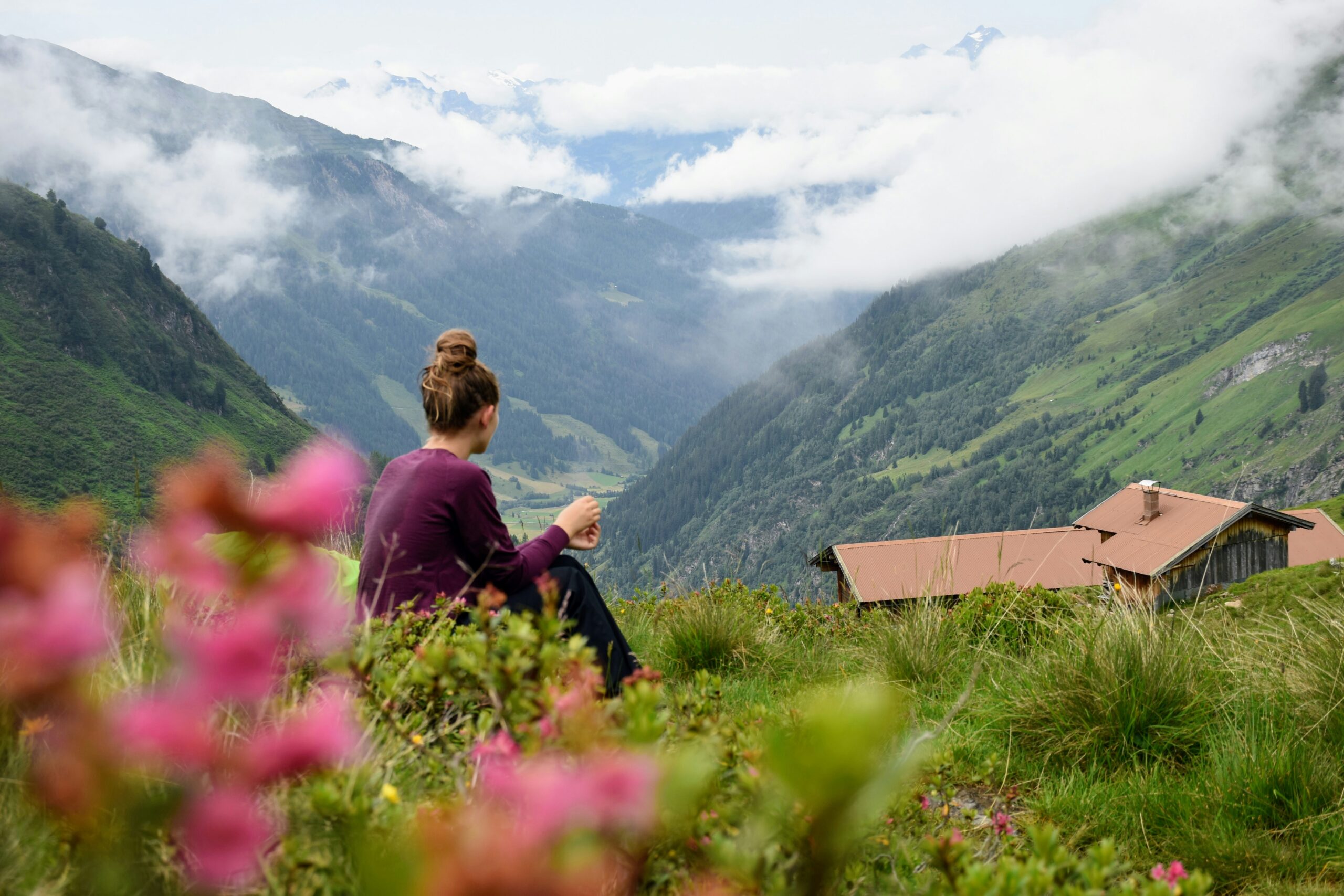 Woman looking over beautiful green mountain valley relaxint