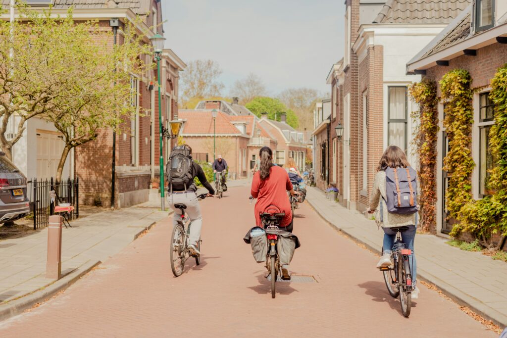 Children ride bikes down a clean street in the Netherlands