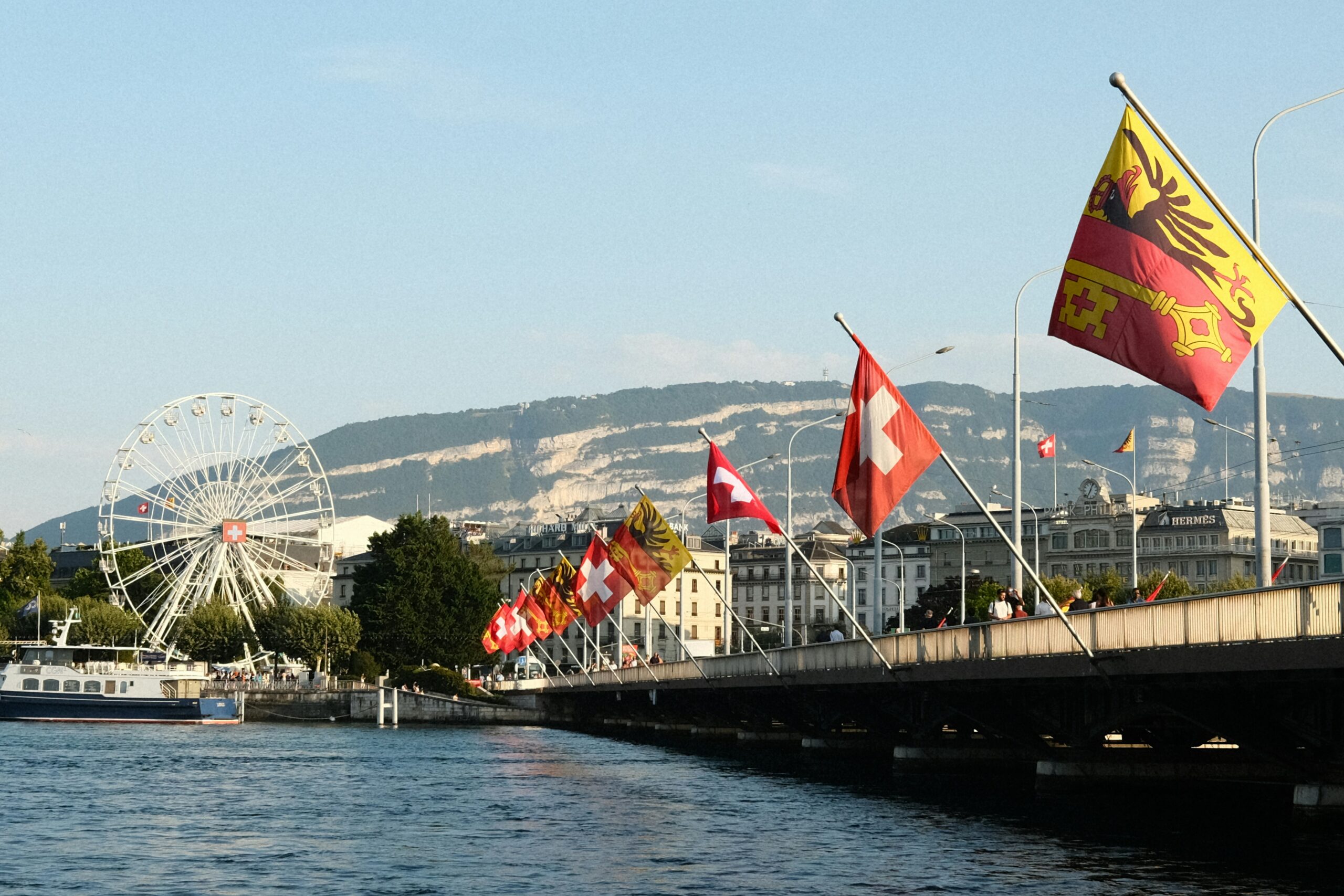 Flags flying from a bridge in Geneva