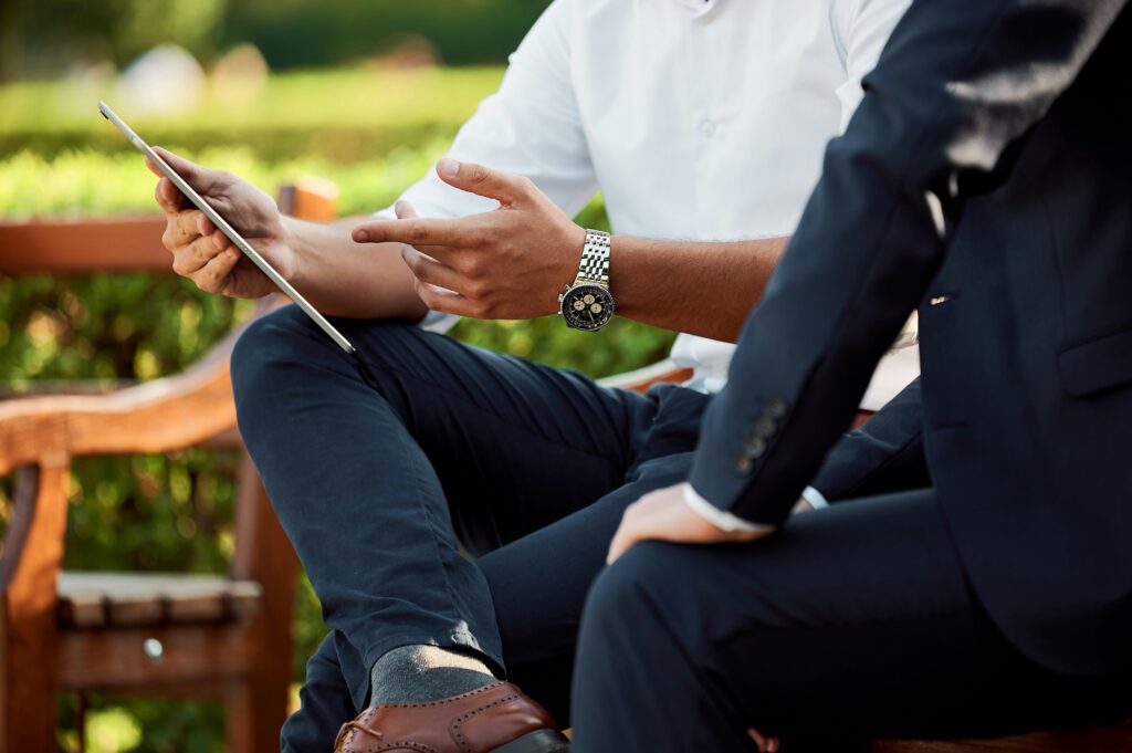 Man with a tablet sitting and showing a client data