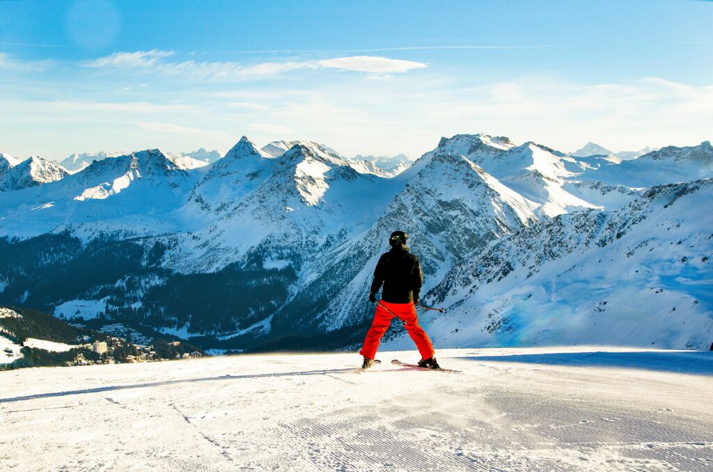A man on skis looks out over the mountains