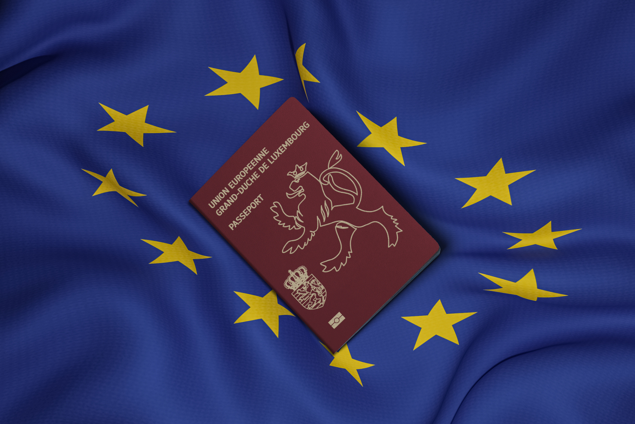 Luxembourg passport on top of the EU flag