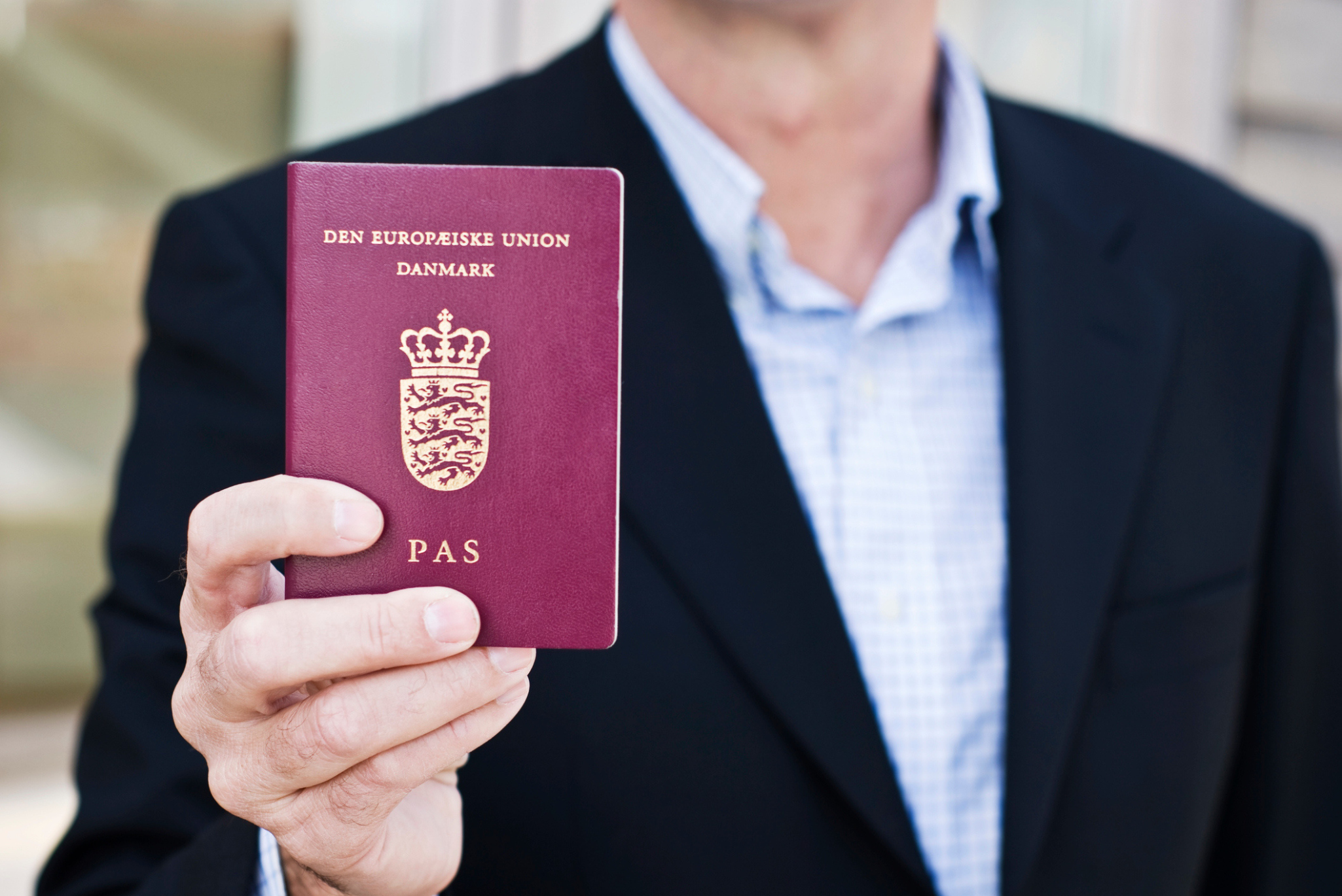 Man holding Danish passport