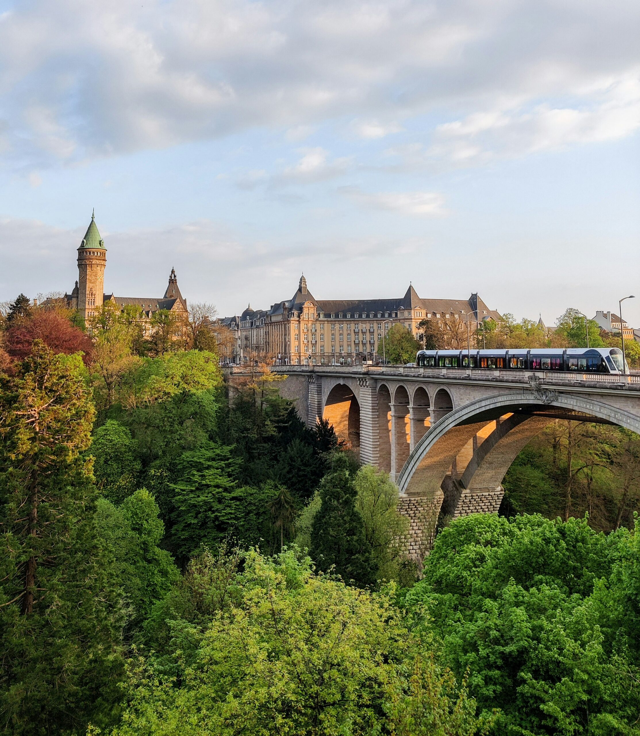 Scenic view of a castle, train, and trees in Luxembourg