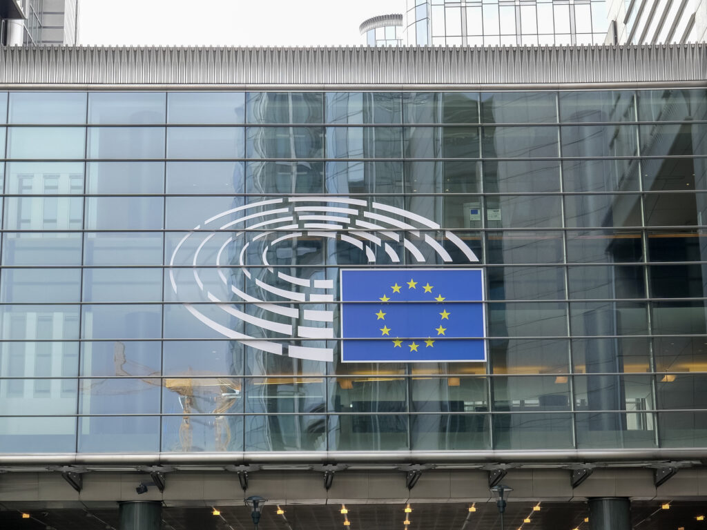 windows with the eu flag at the european union parliament building in brussels, belgium