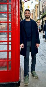 CEO Andrew Primavera standing by a red telephone booth in London
