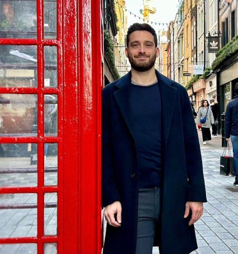 Founder and CEO standing next to a red phone booth in London