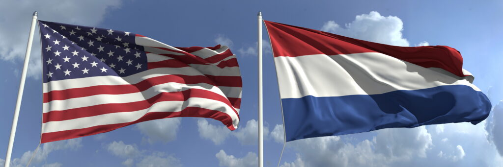 American and Dutch flags on poles